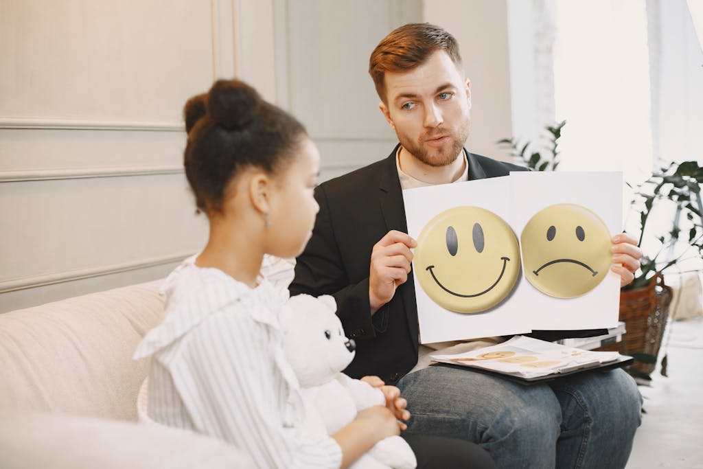 Photograph of a Therapist Showing Emotions to a Child