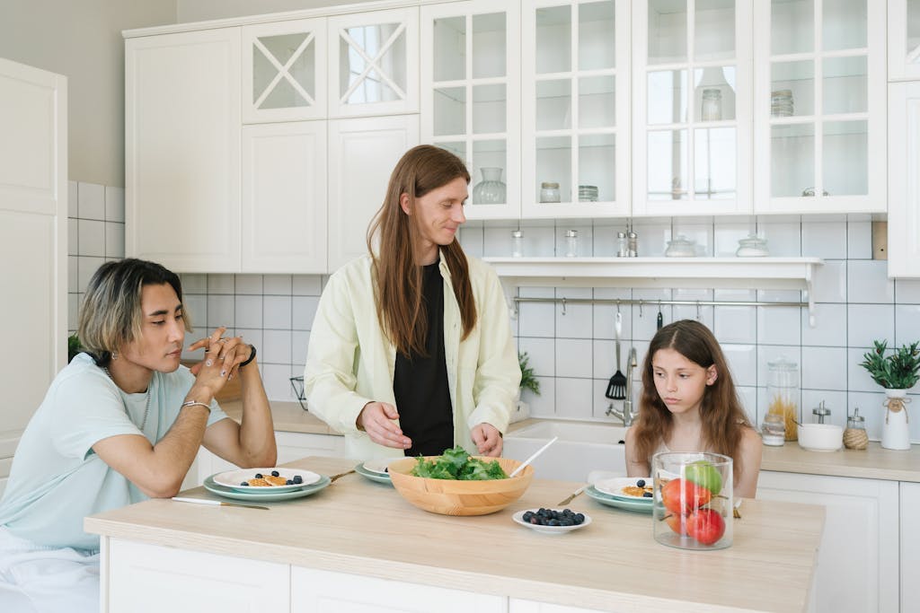 Two Mean and a Child in a Kitchen